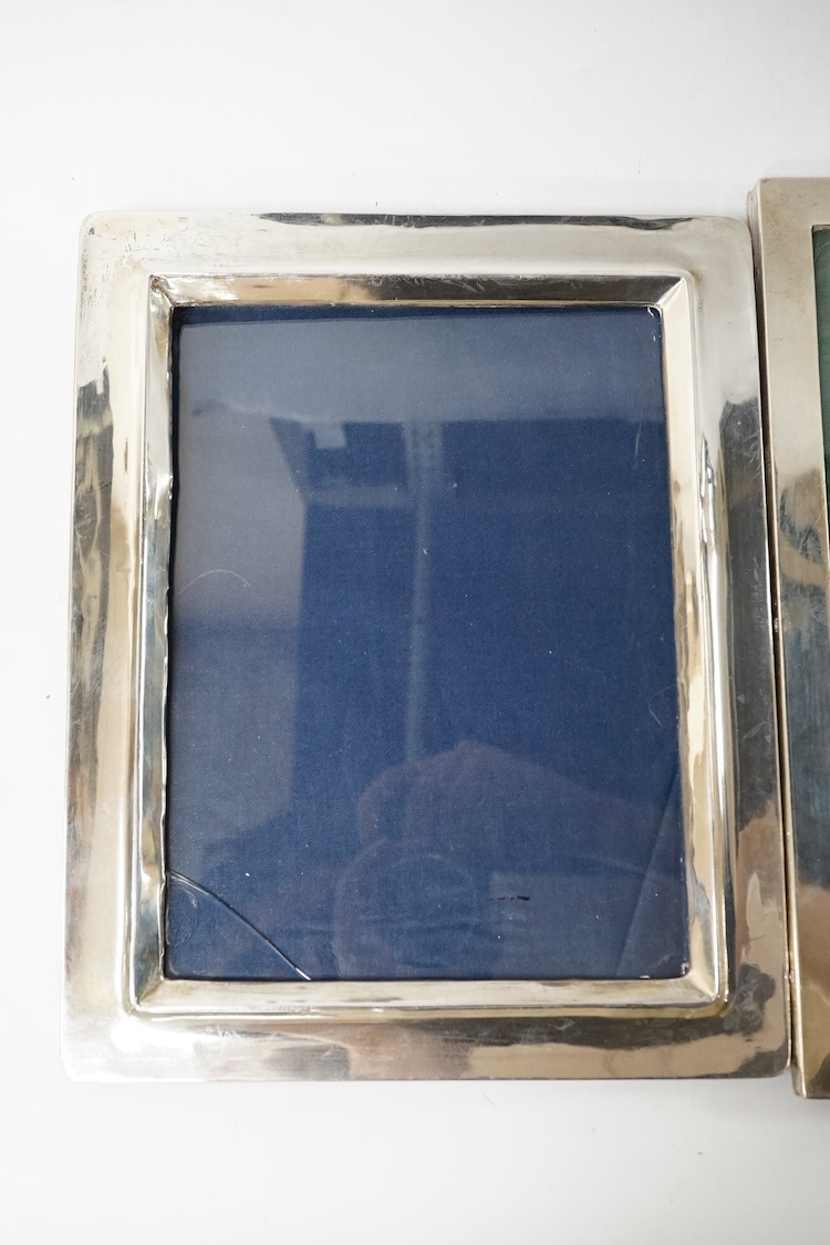 Three assorted early 20th century silver mounted photograph frames, including Birmingham, 1916, (some marks rubbed), largest 27cm. Condition - poor to fair